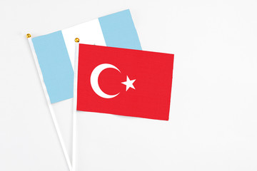 Turkey and Guatemala stick flags on white background. High quality fabric, miniature national flag. Peaceful global concept.White floor for copy space.