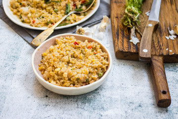 Cooked Turkish bulgur wheat - traditional tabbouleh with vegetables and fresh green coriander.