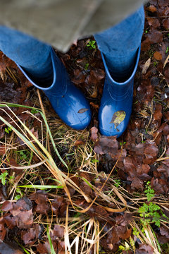 A Woman Wearing Blue Rain Boots