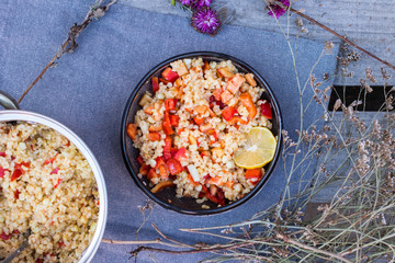 Cooked bulgur wheat mediterranean salad with fresh vegetables and lemon. Tabbouleh - Turkish, Arabian, Levantine traditional pilaf food.