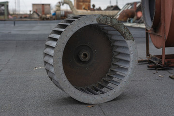 The roof of the factory. The fan wheel is on the roofing material. Around exhaust systems.