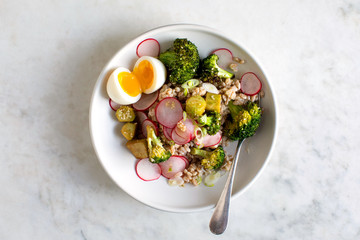 Faro salad with sesame broccoli and poached eggs