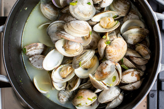 Overhead view of clams in saucepan