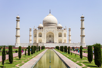 Panoramic view of Taj Mahal with walkway, garden square, reflecting pool and visitors. UNESCO World Heritage in Agra, India