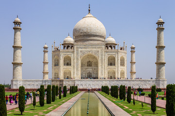 Fototapeta na wymiar View of Taj Mahal with walkway, garden square, reflecting pool and visitors. UNESCO World Heritage in Agra, Uttar Pradesh, India