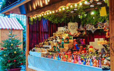Christmas Market stall at Kaiser Wilhelm Memorial Church in Winter Berlin, Germany. Advent Fair Decoration and Stalls with Crafts Items on the Bazaar. German street Xmas and holiday fair