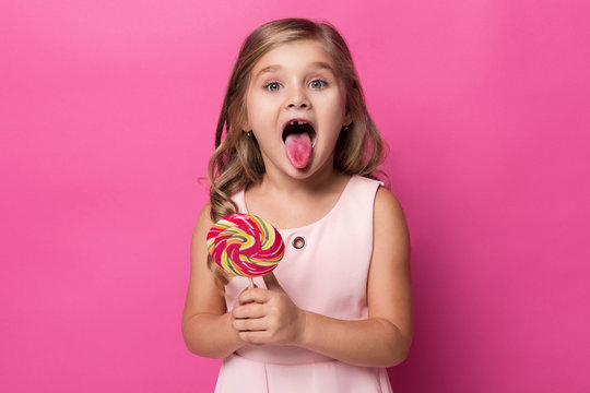 girl shows tongue stained with sweets