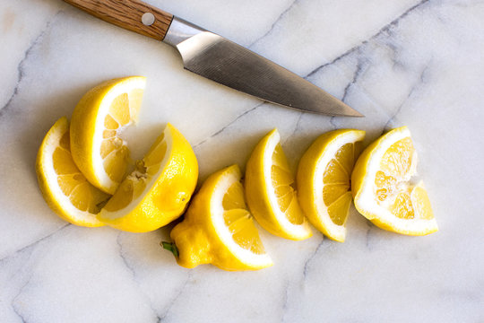 Overhead view of sliced lemon on marble