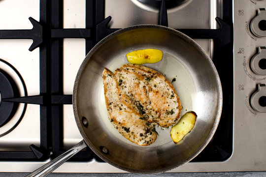 Chicken paillard with black olive tapenade on frying pan