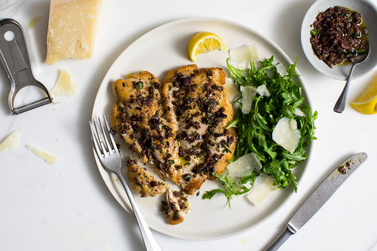 Overhead view of chicken†paillard†with black olive†tapenade