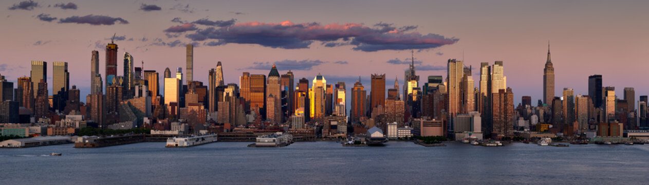 New York City sunset on the skyscrapers of Midtown West. Panoramic view on Manhattan and the Hudson River banks, NY, USA