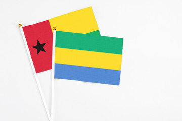 Gabon and Guinea Bissau stick flags on white background. High quality fabric, miniature national...