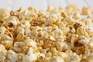Popcorn Background. Golden delicious popcorn-a delicacy of corn. Horisontal. Selective focus.