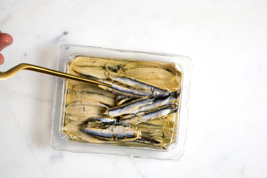 Overhead view of anchovies in oil