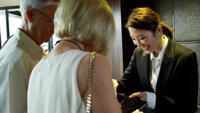 Caucasian seniors using Hong Kong hotel concierge service 