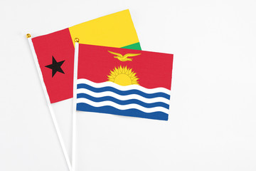 Kiribati and Guinea Bissau stick flags on white background. High quality fabric, miniature national flag. Peaceful global concept.White floor for copy space.