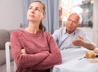 Fototapeta premium Elderly father apologizes to daughter after quarrel