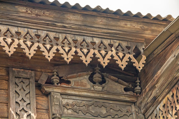 Antique carvings on the cornice and the wall of the old wooden house.