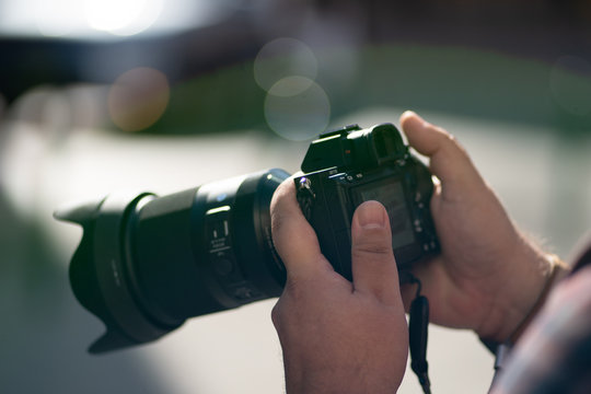 holding a camera close up - Powered by Adobe