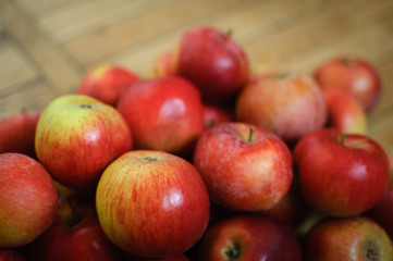 Sweet ripe red juicy apples on wooden background, healthy eating and vegetarian lifestyle concepts.