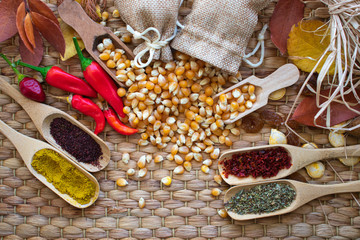 Dry corn in white ceramic bowl isolated on white. Spilled corn kernels and fresh vegetables