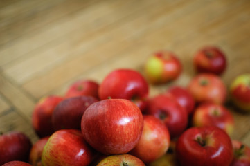 Close-up shot of ripe red juicy apples on wooden background, healthy eating concept, copy space