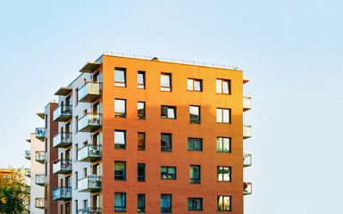 Detail in Modern residential apartment and flat building exterior. Fragment of New luxury house and home complex. Part of City Real estate property and condo architecture. Copy space. Blue sky