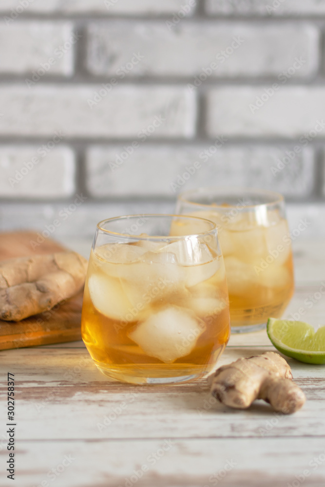 Wall mural fresh ginger ale with lime and ice or kombucha in bottle - homemade lemon and ginger organic probiot