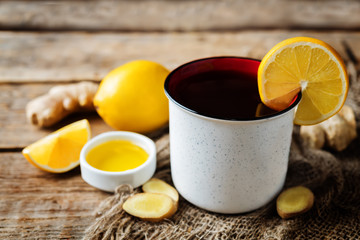 Cup of black tea with honey, lemon and ginger