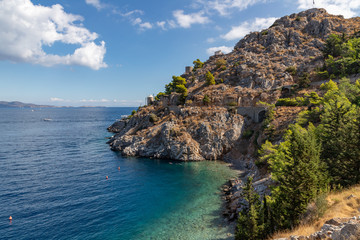 Fototapeta na wymiar Beach with rocks and vegetation in Hydra Island