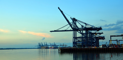 Fototapeta premium Felixstowe Dock Cranes and Container Ships at night.