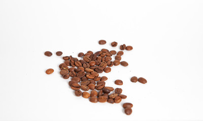 not ground coffee beans sprinkled on a white background