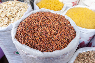 Different kind of ingredients as beans, corn, lentils all filled in bags in a grocery store in Morocco. Typical arrangement of everyday food.