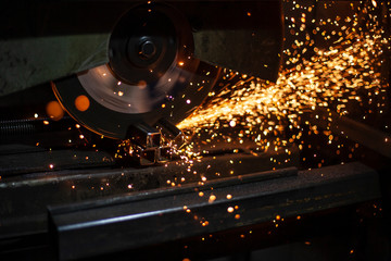 Metal cutting. Sparks from processing a metal profile.