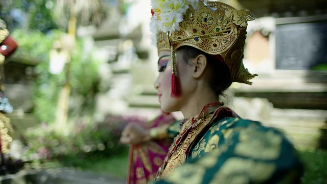 Jewelled costumed Balinese female performing finger dance Indonesia 