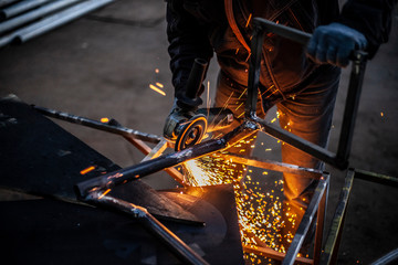 Metal cutting. Sparks from processing a metal profile.