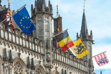 The 14th cenury Stadhuis (City Hall) with National and Regional Flags, Burg Square, Brugge (Bruges), West Flanders, Belgium