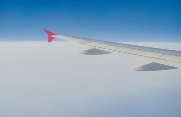 Fototapeta premium wing of the plane, sky, clouds trace from the plane