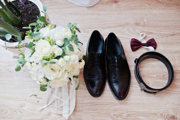 Elegant  men's wedding shoes, bouquet, belt and tie at groom morning.