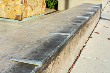 Close up. Skateboard prevention device installed on poured cement surface to prevent damage
