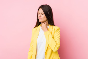 Fototapeta premium Young business woman suffers pain in throat due a virus or infection.