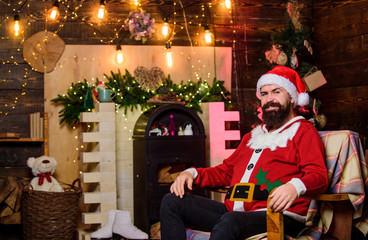Winter holidays. Greetings from Santa. Dear Santa. Santa claus residence. Cozy home atmosphere. Winter decorations. Santa Claus office concept. Bearded hipster man sit in armchair near fireplace