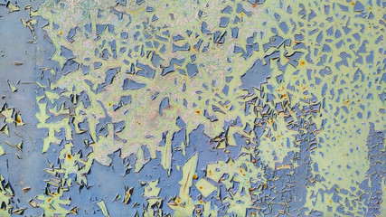 Blue flaking paint on a green surface. Shabby ragged background