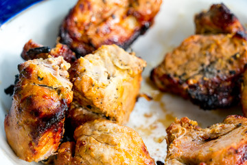 Pieces of kebab removed from skewers and put on a plate.