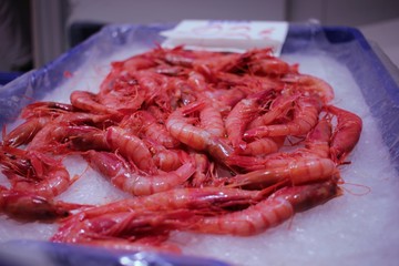 Close-up of a box of fresh prawns at a fish market stall in the market