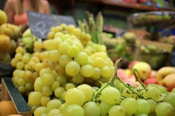 Close-up of a white grape cluster at a market stall