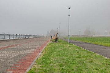 New benches on the waterfront foggy morning