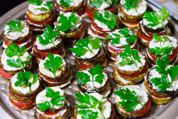 Fried zucchini stacked and served with fresh parsley.