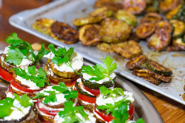 Fried zucchini stacked and served with fresh parsley.