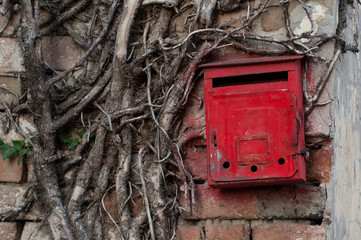 Red old mailbox on the wall. Letter boxes.